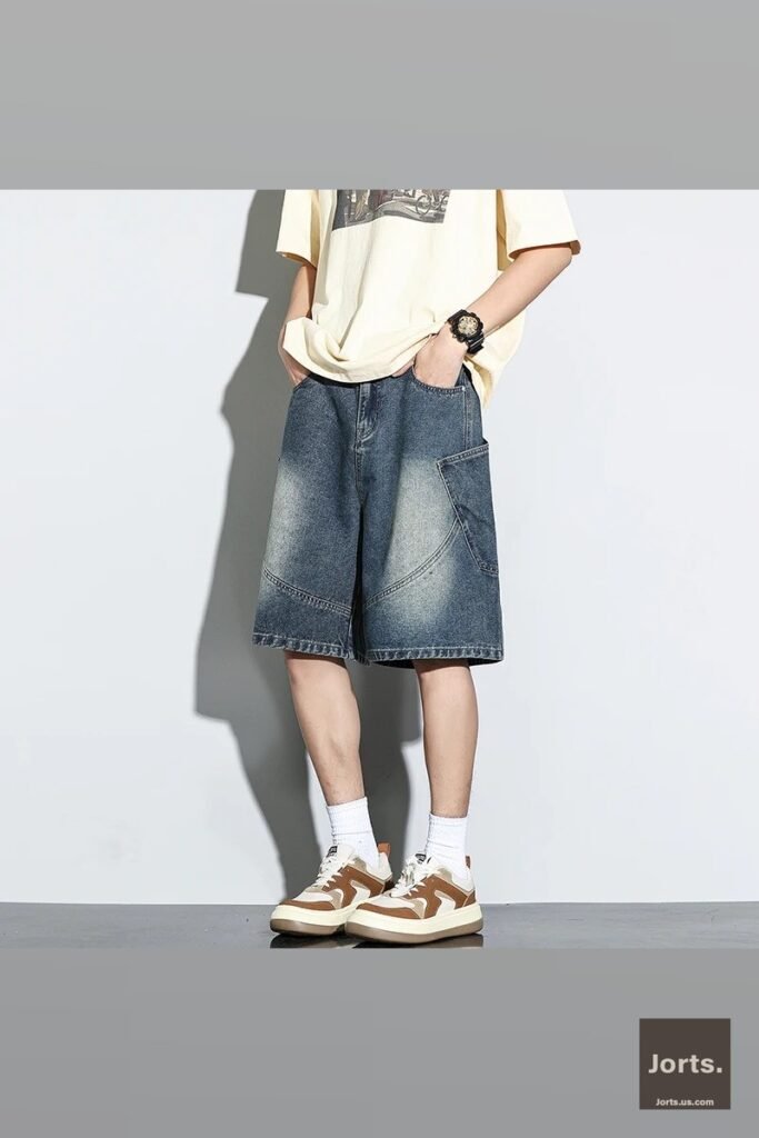 Another full body shot of male model wearing baggy denim shorts, styled for a Harajuku-inspired Y2K look.