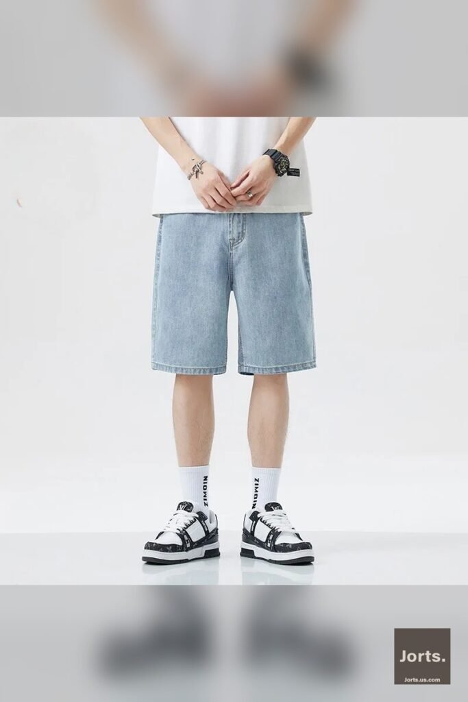 Model sitting down, showing the relaxed fit and length of the baggy jorts.
