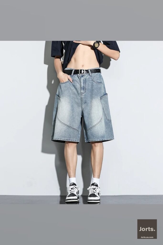 Back view of male model in vintage wash baggy jorts, highlighting the knee-length cut and relaxed silhouette.