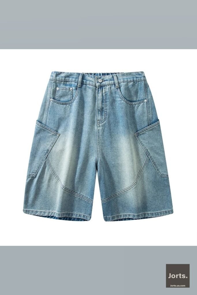 Male model in a full streetwear outfit featuring vintage wash baggy denim shorts, posing casually.