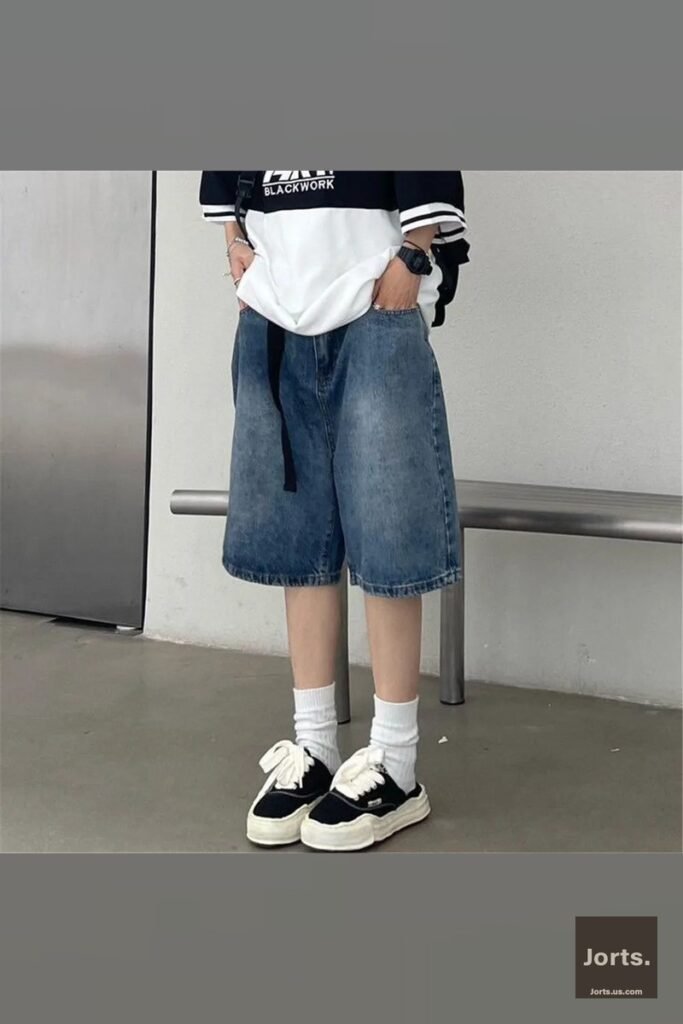 Side profile of model showcasing the loose, wide-leg fit of the Y2K denim shorts.