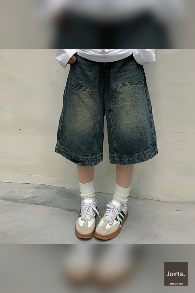 Side view of model wearing loose-fit Y2K baggy jean shorts, showcasing the wide leg style.