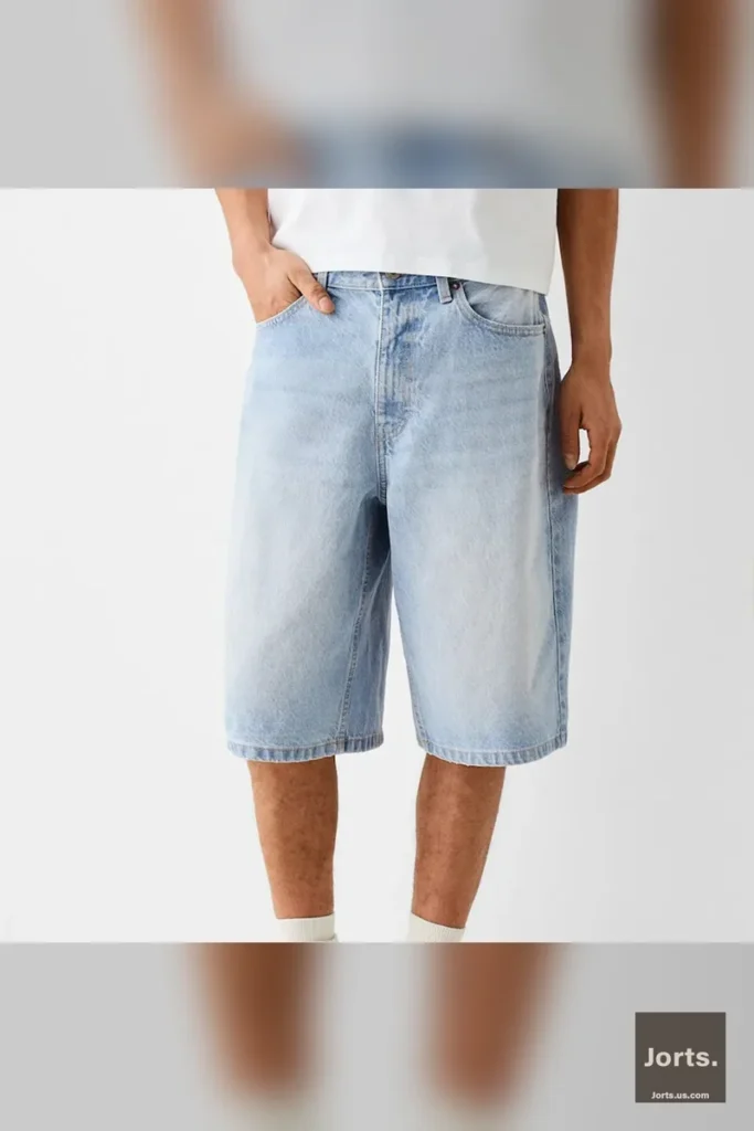 Man in Y2K baggy denim jorts, styled for a skateboard-inspired streetwear outfit
