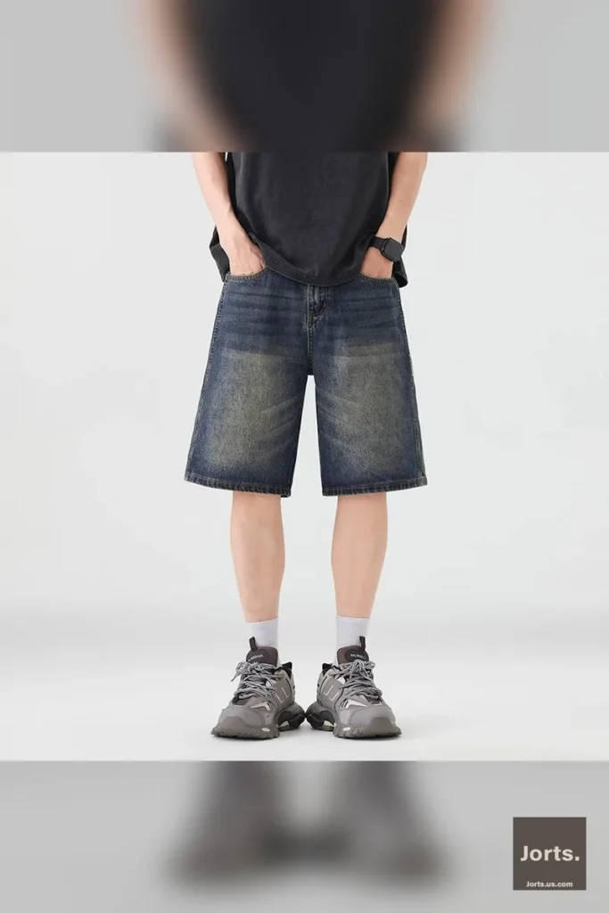 Men's loose fit denim jorts styled casually, showcasing the baggy straight leg and vintage wash.